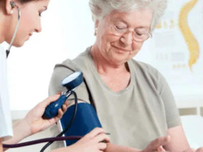 Nurse taking an elderly woman's blood pressure during a 75+ health check at My Doctors Clinic, Surfers Paradise, Gold Coast