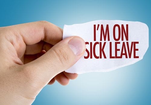 Hand holding a note reading I am on sick leave, representing a GP medical certificate