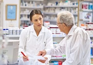 Pharmacist explaining a prescription to an older patient at the pharmacy in Surfers Paradise