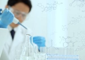 Pharmacy professional measuring ingredients to prepare a compounded medicine