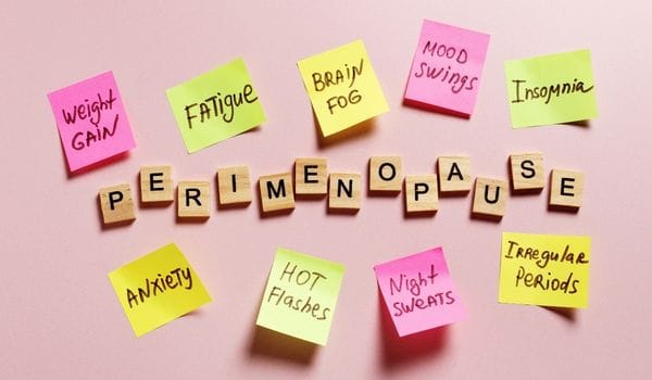 Sticky notes listing perimenopause symptoms including hot flushes, night sweats, brain fog, mood swings, fatigue and irregular periods