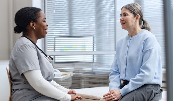 Midlife woman talking with a GP about perimenopause symptoms during a consultation in Surfers Paradise